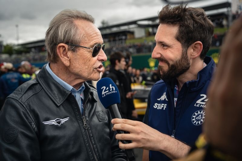 Interview filmée dans le paddock avec un invité en blouson de pilote